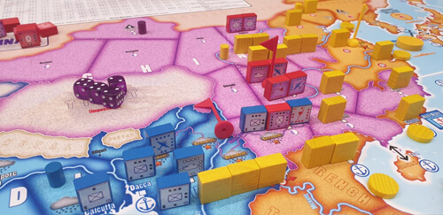 multicolored blocks and purple dice on the map for the orange swan wargame