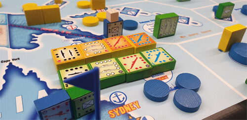 multicolored blocks and wooden markers on the map for the orange swan wargame